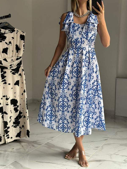 Blue patterned poplin dress with bows on shoulders